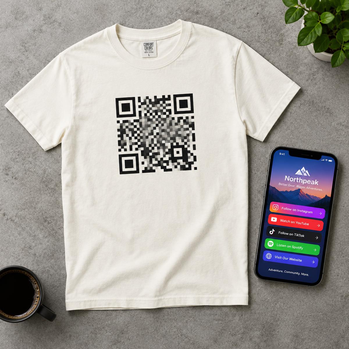 Tee with a printed QR code next to a phone showing a landing page